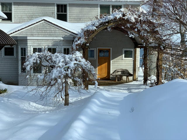 Maine home exterior during a winter property watch visit
